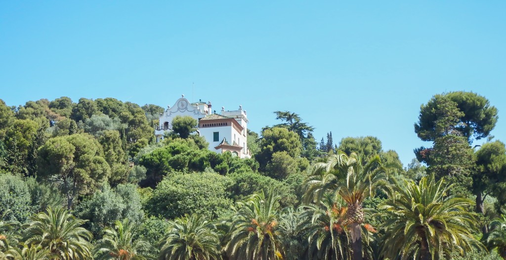 A house in the trees outside Antoni Gaudí's Park Güell in Barcelona, Spain