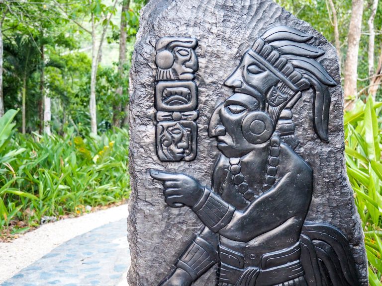 slate carving with maya figures and symbols in belize