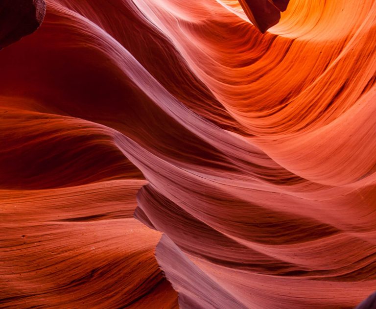 purple, orange, and red swirls of color in a slot canyon