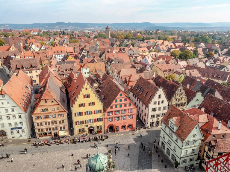 shot of the town from above with red rooftops and towers | One Day in Rothenburg ob der Tauber, Germany: What to do, see, eat, and more. | Rothenburg day trip from Munich, Frankfurt, and others. Rothenburg itinerary for summer, fall, winter, spring. Festivals, things to do, where to park, and where to stay.