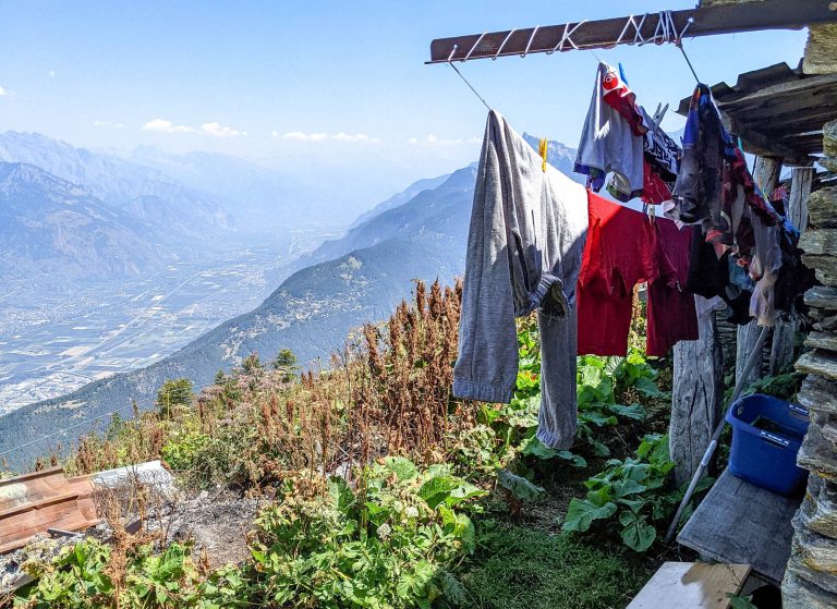 clothes hanging on a clothesline above a big mountain valley