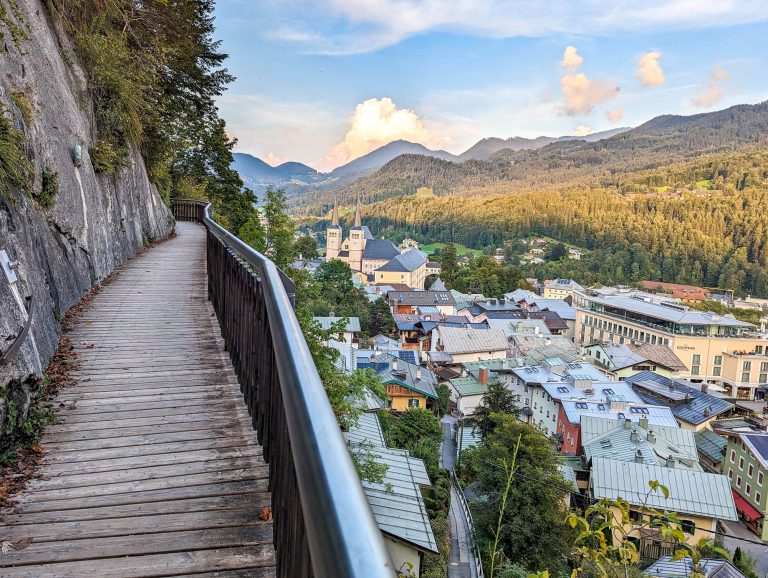 colorful town beneath a wooden walkway on the edge of a mountain