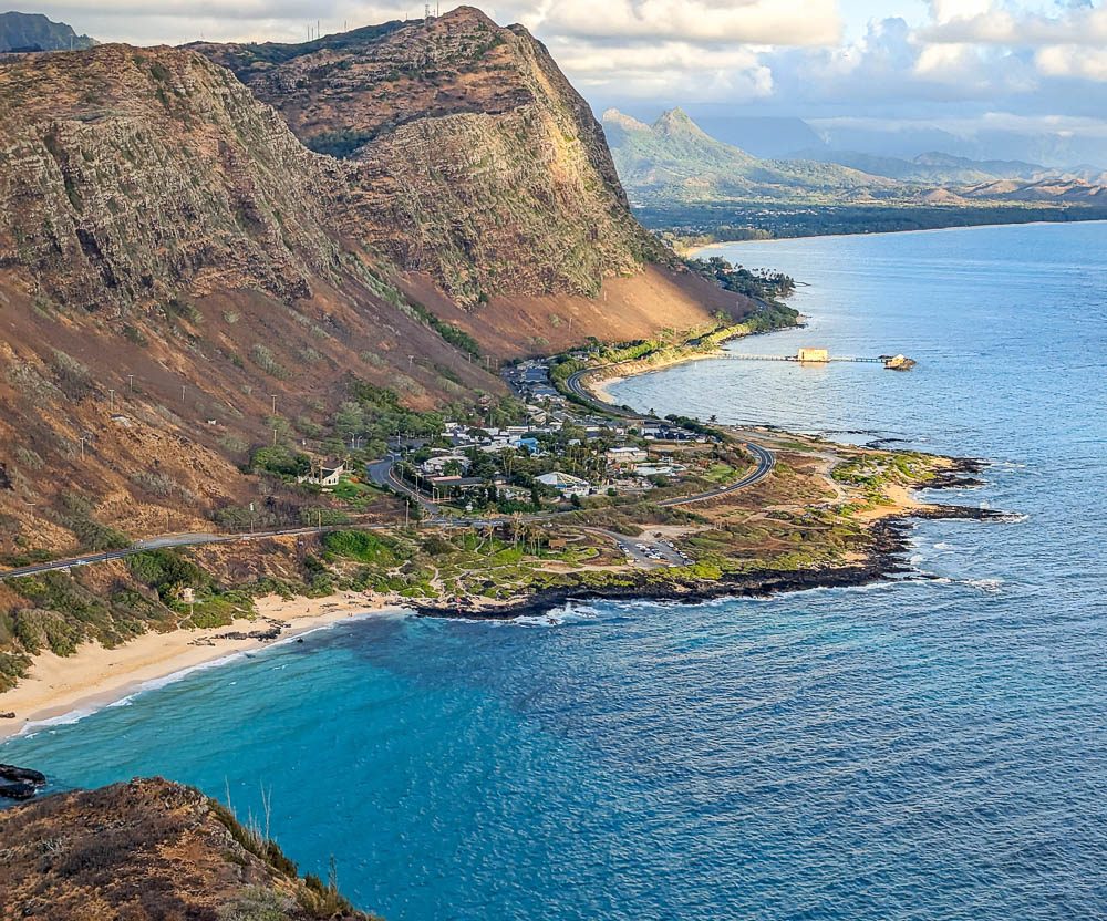 overlooking the ocean and a small group of buildings at the bottom of a cliff